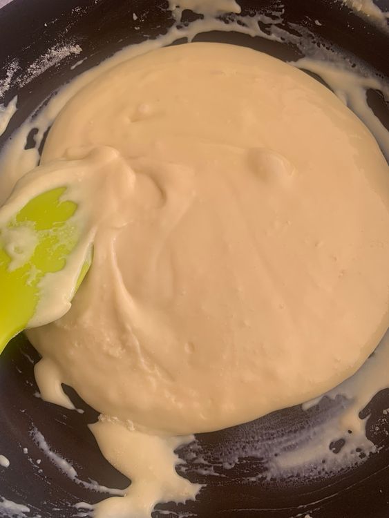 Step 1.1: Gradually add the milk powder and saffron mixture, stirring continuously to prevent lumps
