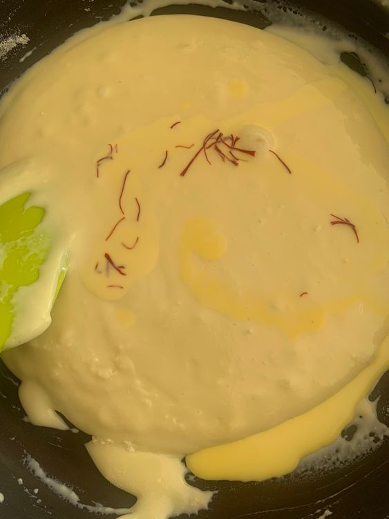 Step 1.2: Gradually add the milk powder and saffron mixture, stirring continuously to prevent lumps