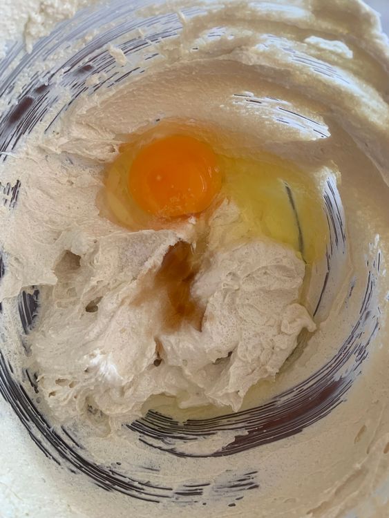 Step 1.1: Add the egg and vanilla extract to the butter-sugar mixture and whisk until the mixture becomes light and frothy