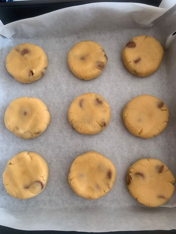 Step 1.1: Arrange the flattened dough balls on the prepared baking sheet, leaving space between them to allow spreading while baking