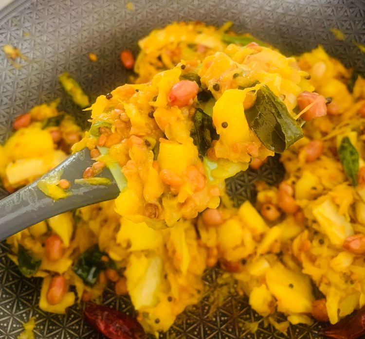 Step 1.2: Add the grated raw mango and turmeric powder to the pan