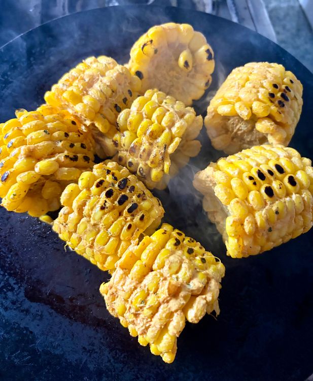 Step 3.1: Place the marinated corn cobs on the hot tawa or pan and grill, rotating frequently, until golden, lightly charred, and evenly cooked on all sides