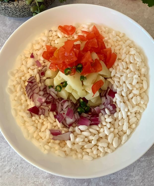 Step 1.1: In a large mixing bowl, add the puffed rice, chopped onions, boiled potatoes, chopped tomatoes, and green chilli