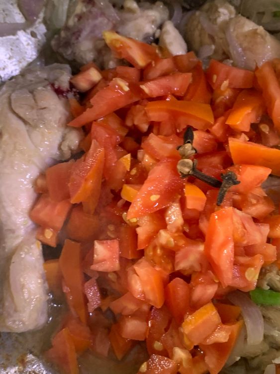 Step 1.1: Add chopped tomatoes and cloves, stir to combine and cook for 3-4 minutes
