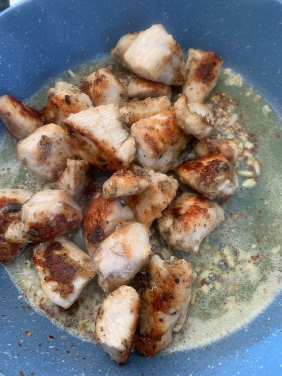Step 1.1: Return the chicken pieces to the skillet, tossing them in the garlic butter mixture