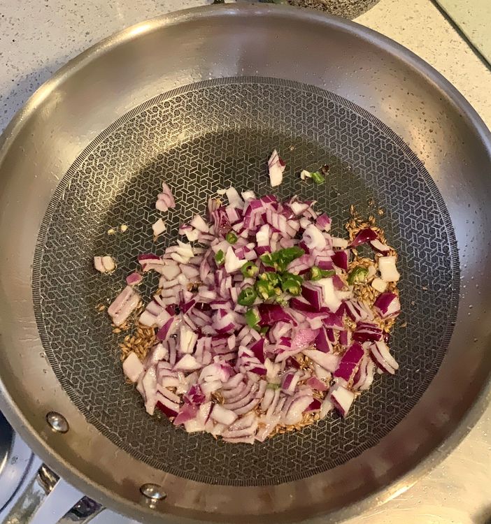 Step 1.1: Add the chopped onions and green chillies to the pan