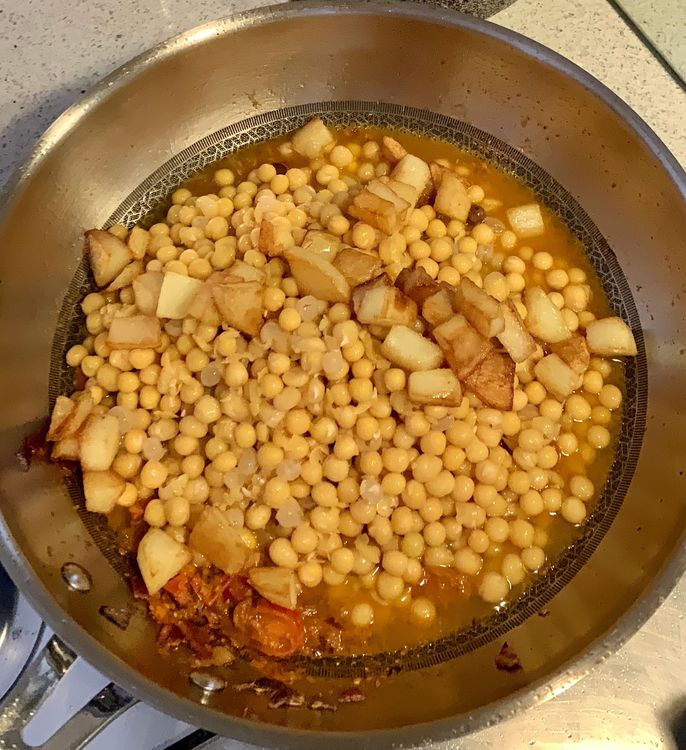 Step 1.1: Add the cooked peas and fried potatoes to the pan, and mix everything together
