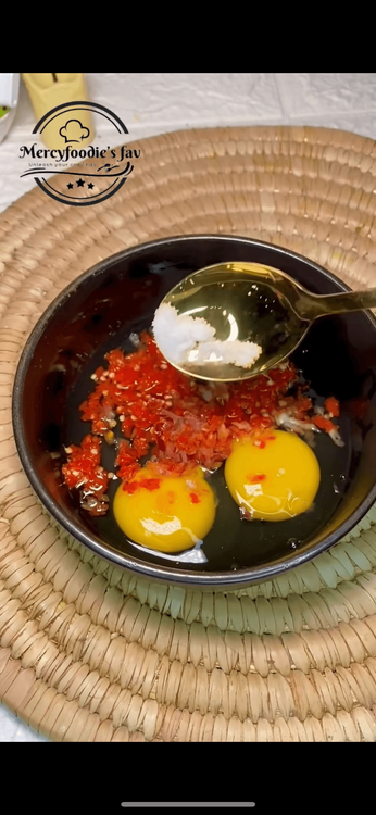 Step 2.2: Put two eggs in a bowl and mix with fresh pepper, Titus fish, onion and salt, then fry in a low heat