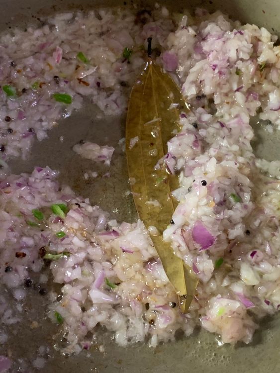 Step 1.2: Add the finely chopped onions and green chillies to the pan