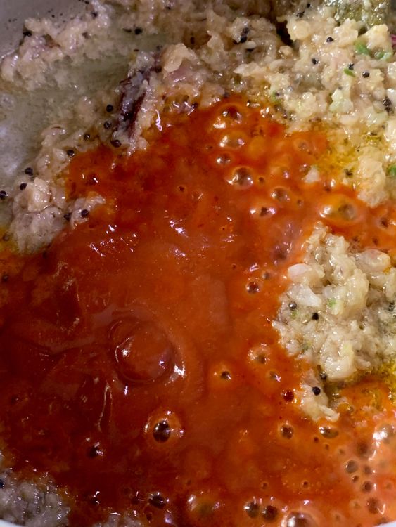 Step 1.1: Add tomato puree and mix well