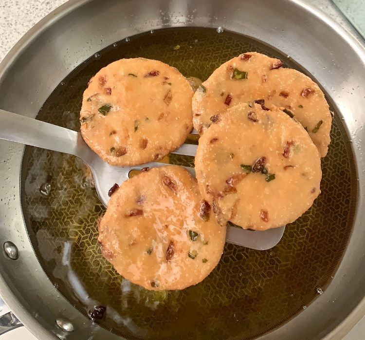 Step 1.2: Slide the vada into the hot oil and fry on medium heat until one side becomes slightly golden