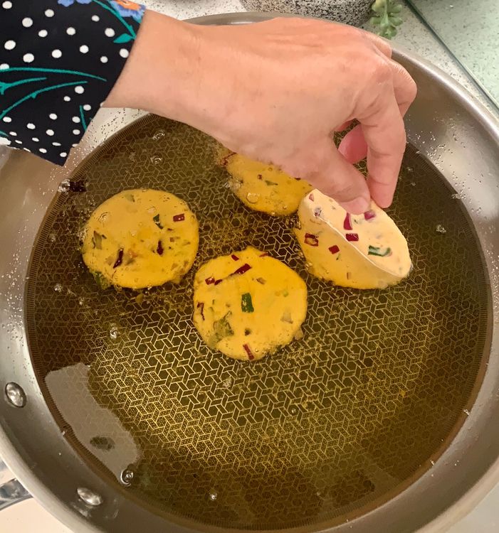 Step 1.1: Slide the vada into the hot oil and fry on medium heat until one side becomes slightly golden