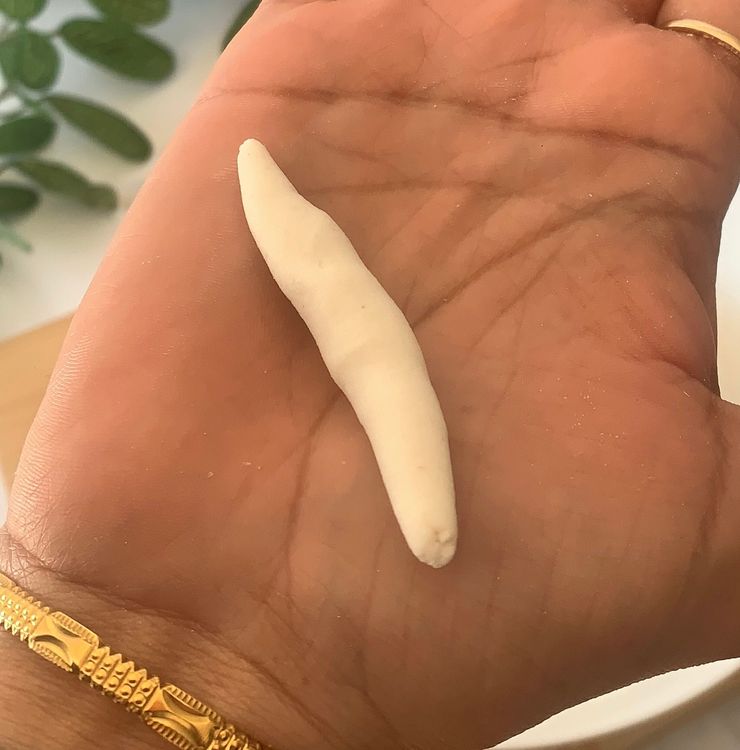 Step 1.1: Grease your palms with oil, divide the dough into small portions and shape them into cylindrical shapes