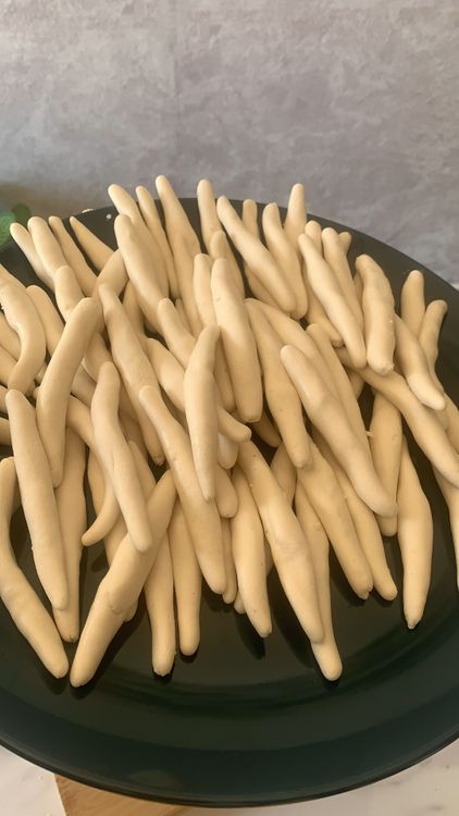 Step 1.2: Grease your palms with oil, divide the dough into small portions and shape them into cylindrical shapes