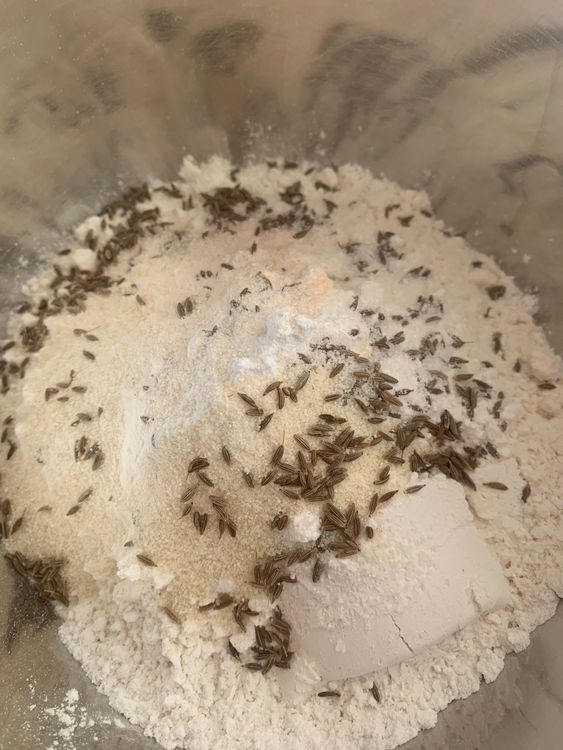 Step 1.1: In a mixing bowl, combine the all-purpose flour, rice powder, semolina, cumin seeds, and salt