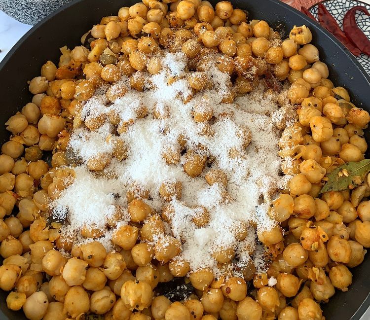 Step 1.1: Add the masala mix and coconut to the pan and mix well until the legumes are nicely coated