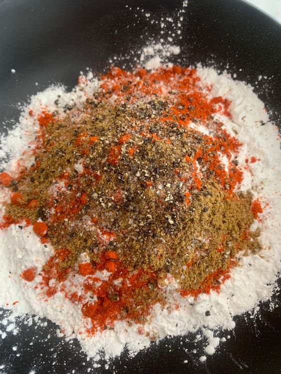 Step 2.1: Combine rice flour, cornflour, Kashmiri red chili powder, garam masala, salt, cumin powder, and freshly ground black pepper in a large mixing bowl