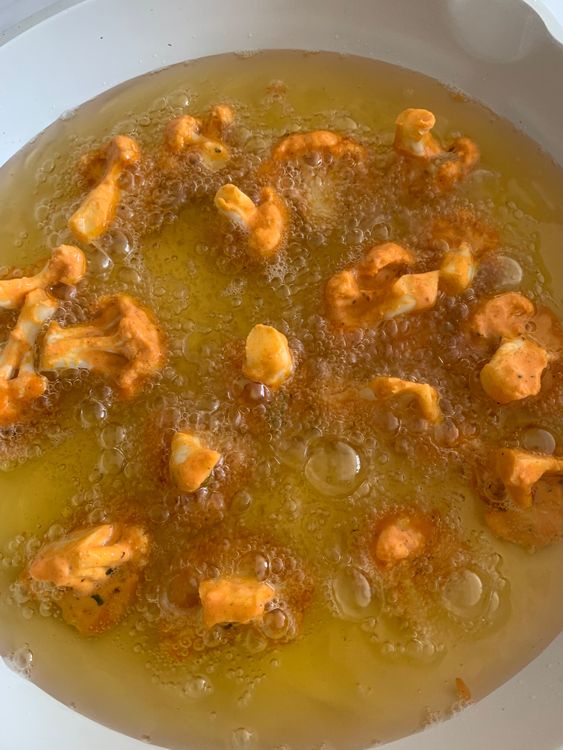Step 4.1: Add the coated florets to the hot oil in batches