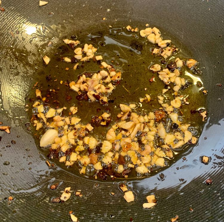 Step 4.1: Add chopped garlic and slit green chilies