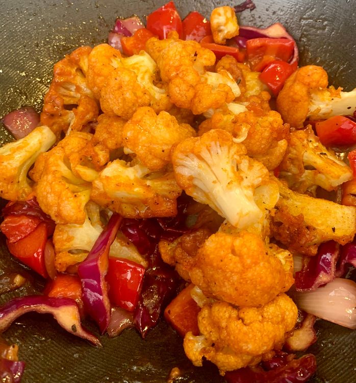 Step 4.1: Add the fried cauliflower florets to the pan with the vegetable and sauce mixture