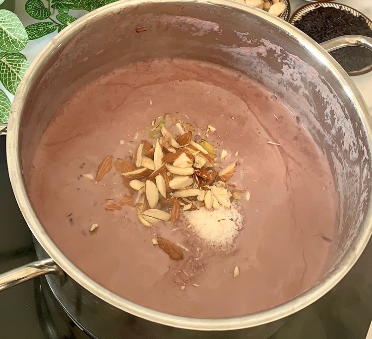 Step 1.1: Once the milk has thickened and the rice is nearly cooked, add the sugar, grated coconut, pinch of salt and chopped nuts