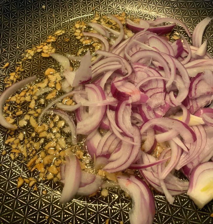 Step 1.1: Add the sliced onions to the wok and mix well