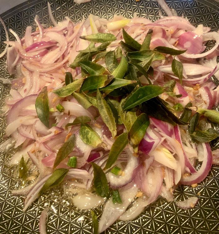 Step 1.2: Add the sliced onions to the wok and mix well