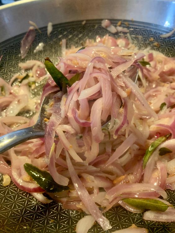 Step 1.3: Add the sliced onions to the wok and mix well