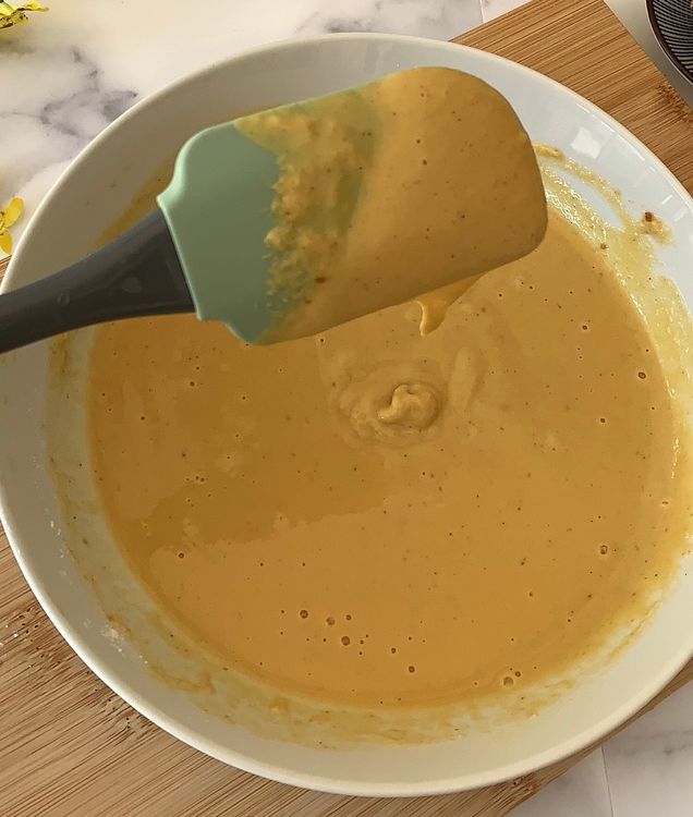 Step 1.1: Gradually add water to the mixture while whisking to form a smooth batter consistency with no lumps