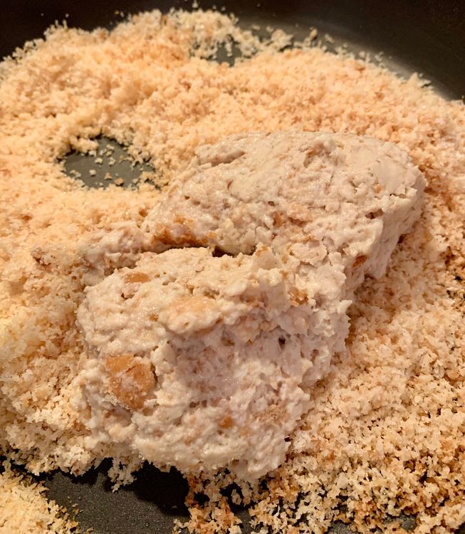 Step 1.1: Add the crushed bread mixture to the pan