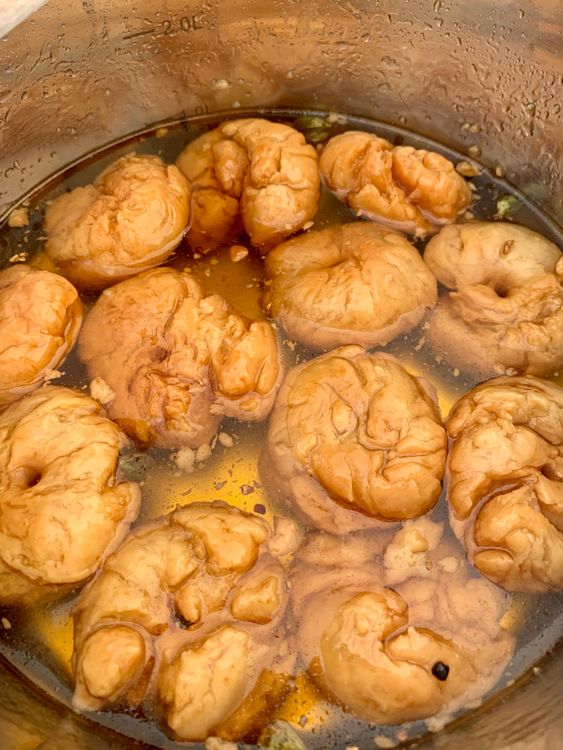 Step 2.1: Dip each balushahi in warm sugar syrup for 5-7 minutes to ensure they are well-soaked and slightly juicy