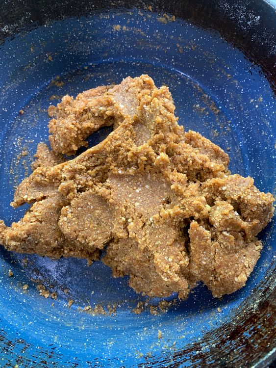 Step 2.2: Reduce the heat to low, then add the ground nut and makhana mixture to the jaggery syrup