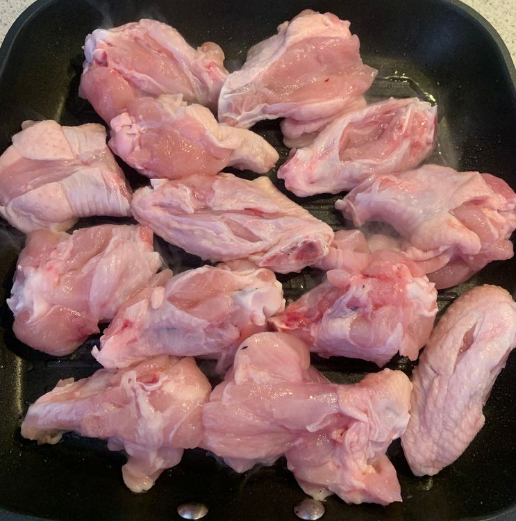 Step 1.1: Sear the chicken wings in the hot oil until they become golden brown and tender