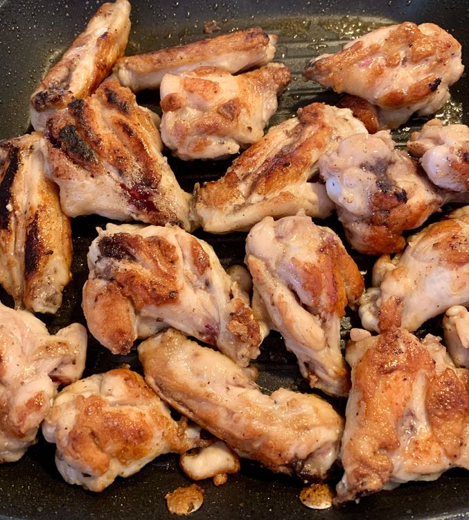 Step 1.2: Sear the chicken wings in the hot oil until they become golden brown and tender