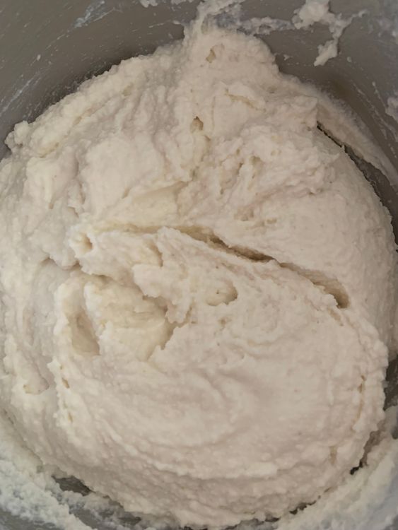 Step 1.2: Gradually add water to the mixture, stirring continuously, until a medium-thick, easy drop consistency idli batter forms without any lumps