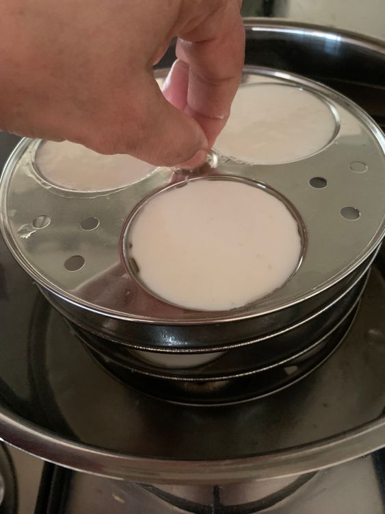 Step 1.1: Place the idli moulds with batter into the pot, and cover it with a lid