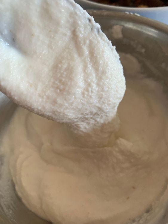 Step 1.3: Gradually add water to the mixture, stirring continuously, until a medium-thick, easy drop consistency idli batter forms without any lumps