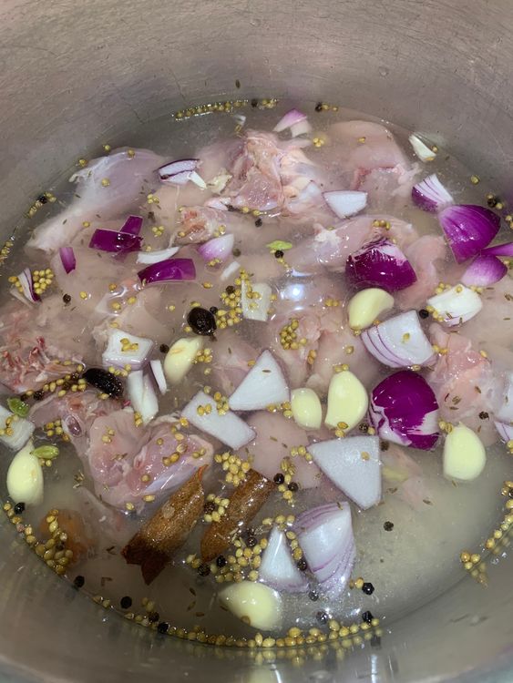 Step 2.2: In a large pot, combine chicken, garlic, ginger, onion, cumin seeds, coriander seeds, green cardamoms, black cardamoms, cinnamon sticks, cloves, mace flower, black peppercorns, lemon juice, salt, and water