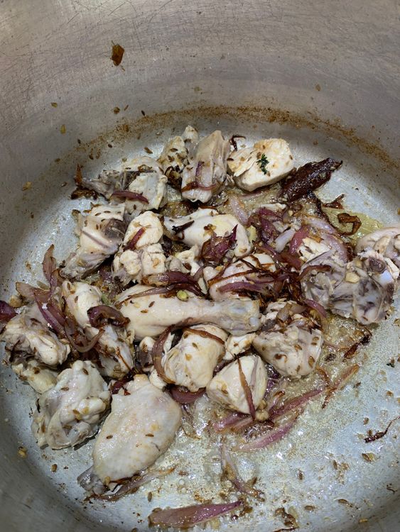 Step 3.1: Add the reserved chicken pieces, stirring well to coat them in the spices, and cook for 2-3 minutes