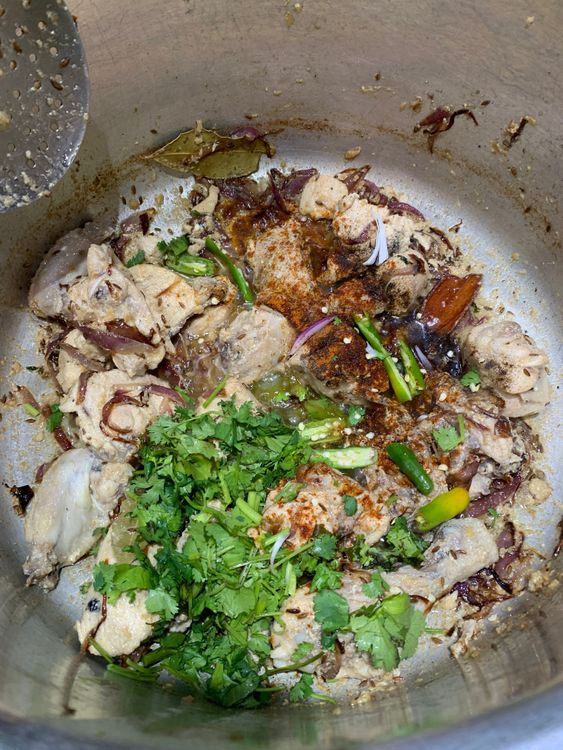 Step 3.1: Pour in the whisked yogurt, red chilli powder, black pepper powder, chopped fresh coriander, and slit green chillies