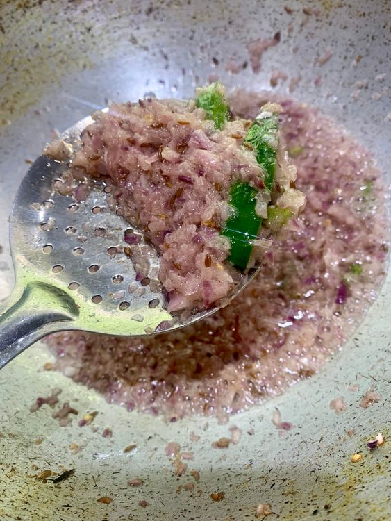 Step 4.2: Add the finely chopped onions, cooking until they soften and turn a light pink