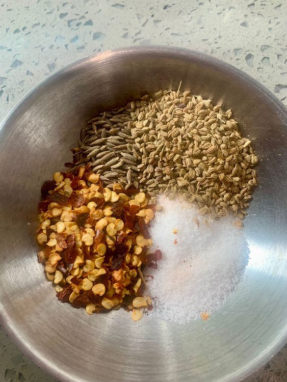 Step 1.1: Add salt, cumin seeds, red chilli flakes, and carom seeds