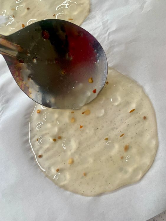 Step 2.1: Spread the mixture thinly into round papad shapes using the back of a spoon