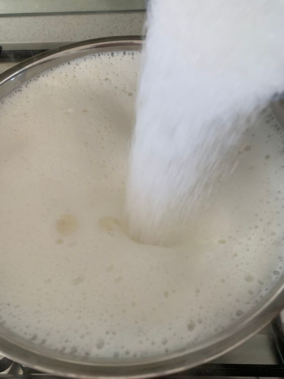 Step 1.1: Add sugar, cardamom powder, rock salt and powdered nuts to the pan