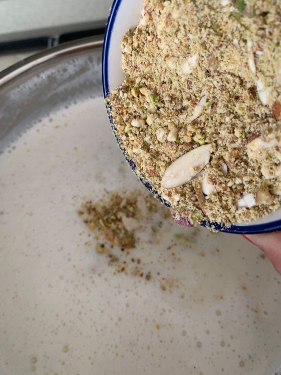 Step 1.2: Add sugar, cardamom powder, rock salt and powdered nuts to the pan