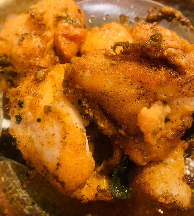 Step 4.2: Carefully place the marinated fish into the hot oil in batches