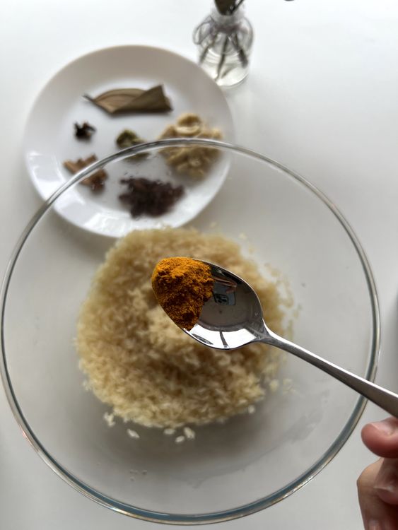 Step 1.1: Mix turmeric, salt, and sugar into the rice and stir well