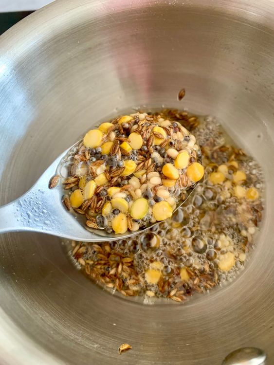 Step 2.1: Stir in the channa dal and urad dal, and sauté until they turn golden brown