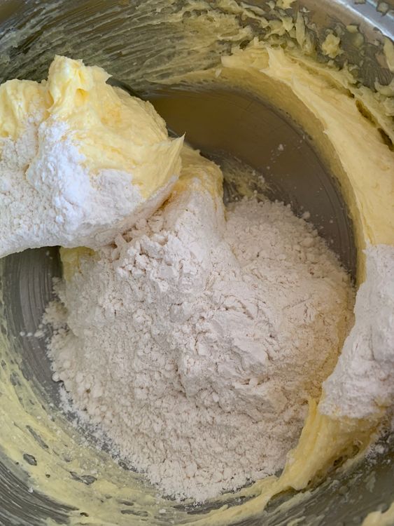 Step 1.1: Gradually add the sifted flour and salt to the butter mixture