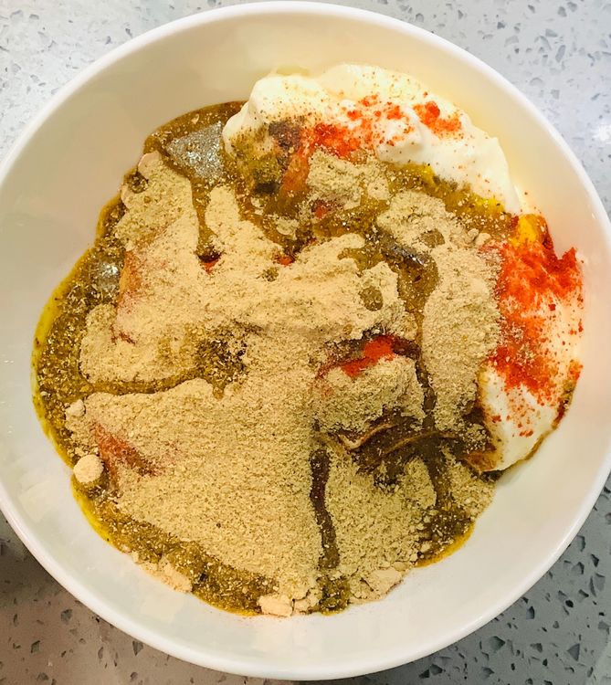 Step 1.1: In a mixing bowl, combine a tbsp of ginger garlic paste, kashmiri red chilli powder, amchur, chaat masala, ground black peppercorns, cumin powder, coriander powder, salt, and 2 tbsp of mustard oil with the yogurt